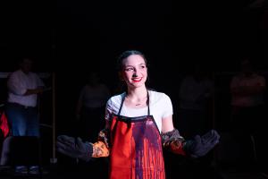 Woman standing smiling in Working: The Musical Theatre production.
