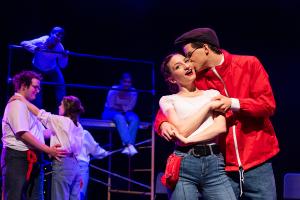 Male kissing female on the cheek during Working: The Musical Theatre production 