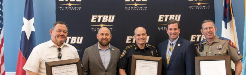 ETBU President J. Blair Blackburn and Vice President for Enrollment and Administrative Affairs Kevin Caffey present Harrison County Sheriff Tom McCool, Marshall Police Department Chief Cliff Carruth, and Texas Department of Public Safety Corporal Kevin Arnold during the annual Law Enforcement Appreciation Luncheon on May 14. 