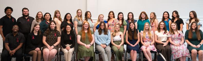 Students pose for a group photo after being inducted into the Alpha Lambda Delta Honor Society