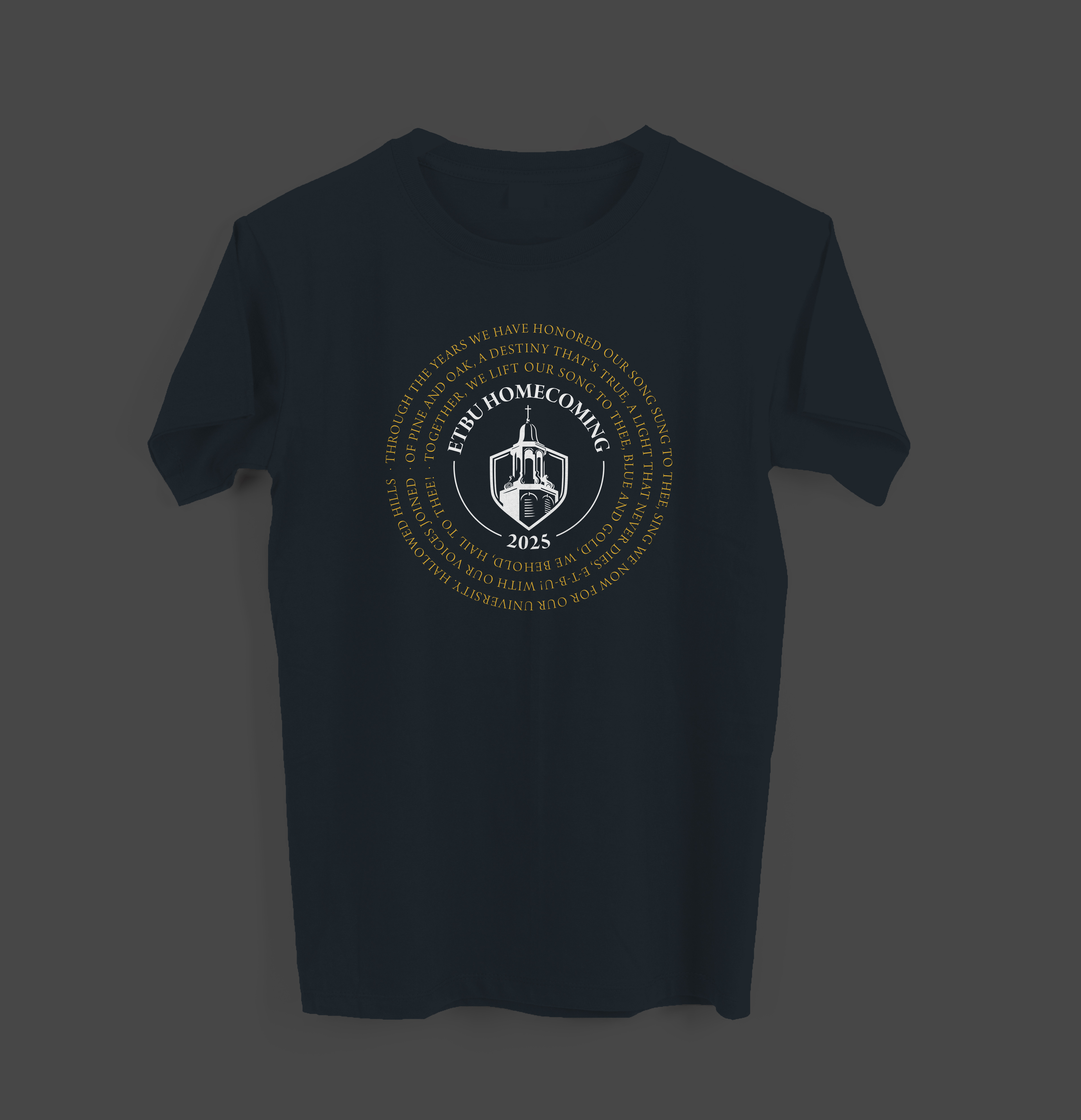  A navy blue t-shirt featuring "ETBU Homecoming 2025" with various symbols of East Texas Baptist University in gold and white.