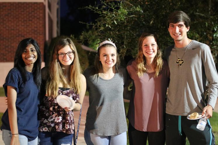A group of people outside smiling together