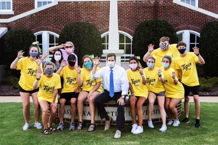 Group of students in masks with President