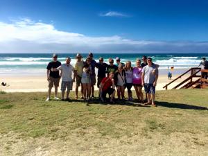 a group of people standing on the beach