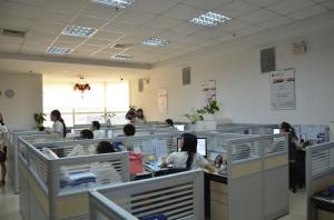 a photo of office cubicles with several people inhabiting them