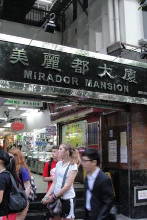 Entrance to Mirador Mansion with a busy street scene.