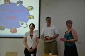 a photo of 3 people stood in front of a projector screen
