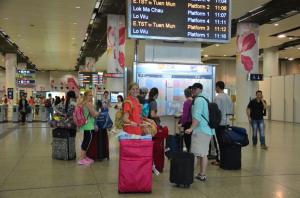a group of people inside at an airport with baggage