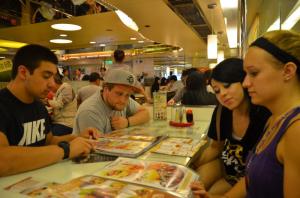 people sitting at a table together with restaurant menus