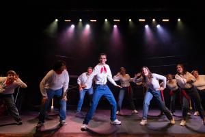 Group of actors standing on stage in Working: The Musical Theatre production.