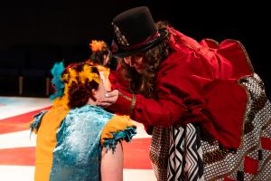 Woman joyfully holding another woman's face during Cagebirds Theatre Production