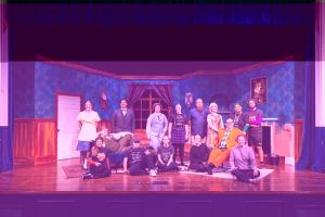 a group of people on a stage posing for a picture