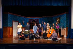A group of ETBU Theatre students taking a group photo on stage.