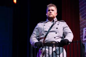 A  man in military clothing during a monologue in a play