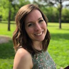 Megan Smith A woman smiling at the camera in front of grass and trees