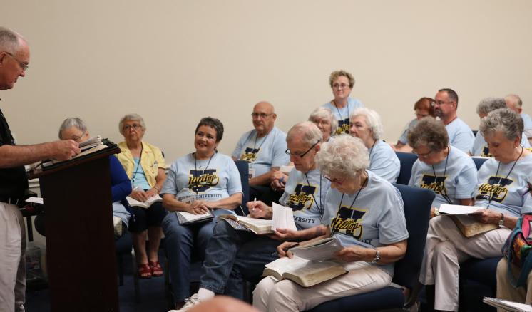 Hilltop University participants take notes in class