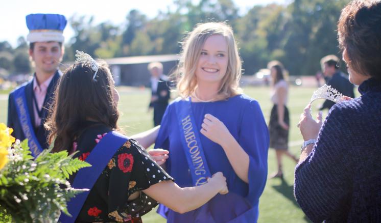 The 2018 Homecoming Queen, Caroline Lowe, is crowned by ETBU First Lady Michelle Blackburn and 2017 Homecoming Queen Halee Vasquez. ETBU President J. Blair Blackburn crowned Homecoming King, Collin Perkins, during the Homecoming halftime.