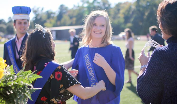 The 2018 Homecoming Queen, Caroline Lowe, is crowned by ETBU First Lady Michelle Blackburn and 2017 Homecoming Queen Halee Vasquez. ETBU President J. Blair Blackburn crowned Homecoming King, Collin Perkins, during the Homecoming halftime.