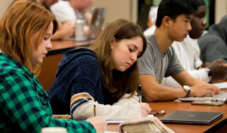 During the Introduction to New Testament Mini-Term with Assistant Professor of Religion Jeremy Greer, junior Chloe Wright, freshman Lauren House, and freshman Eric Hood take notes. 