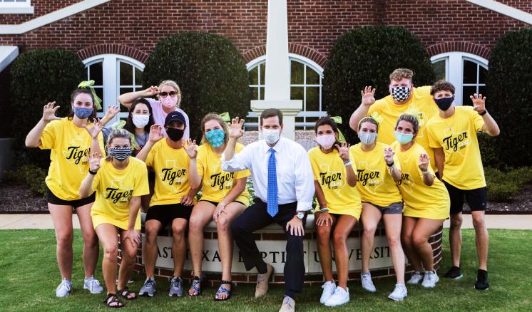 Group of students in masks with President