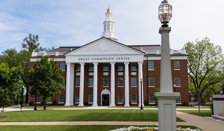 A brick academic building at East Texas Baptist University with a blue sky in the background.