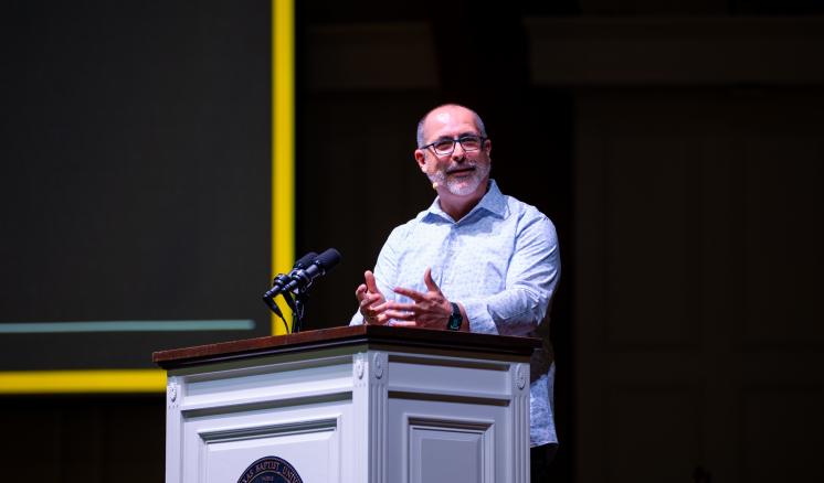 A man speaking from behind a podium