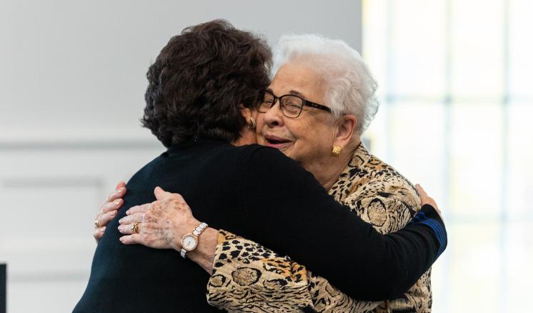 Two women hugging each other 