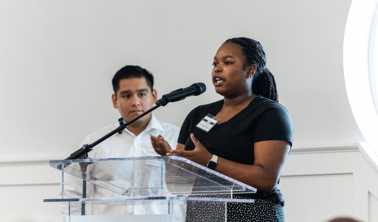 Female student speaking behind podium.