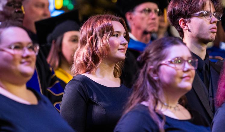 Student choir members singing during commencement