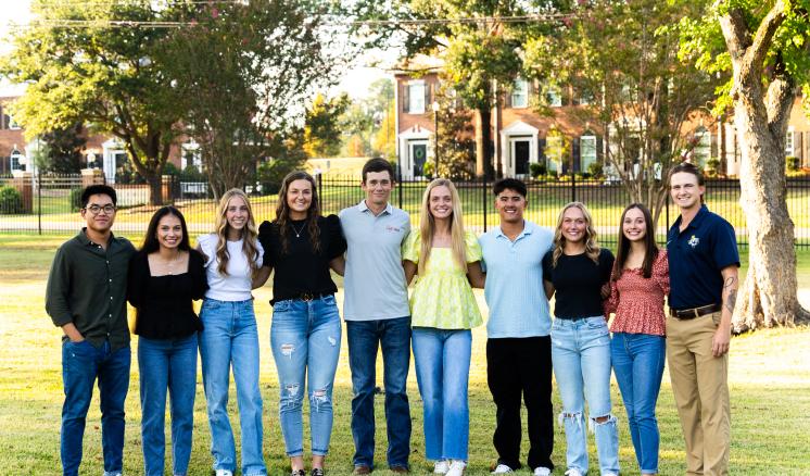 2023_student_photoshoot_september_2023_0055 Group of male and female students smiling at the camera outdoors