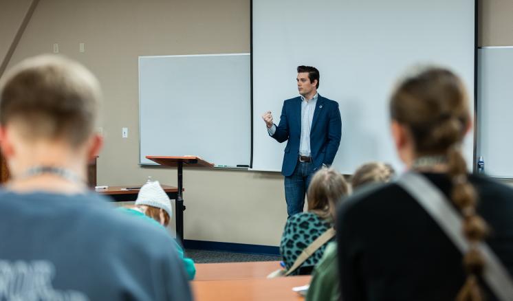 Man talking in front of a group of students 