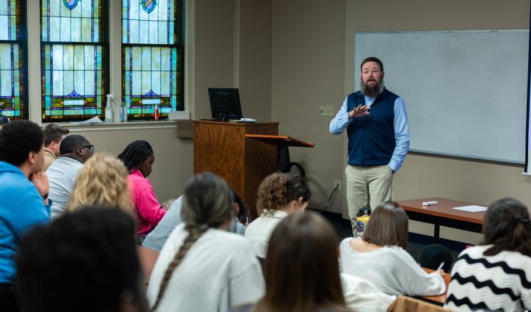 Man speaking to students in a classroom 