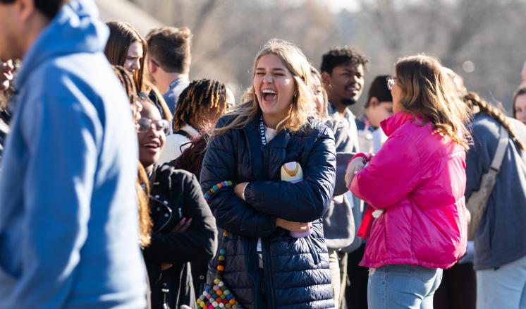 Female student laughing outdoors