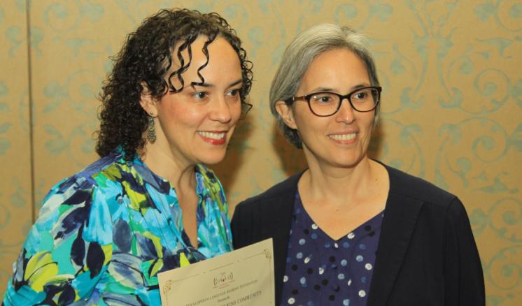 two women smiling at camera 