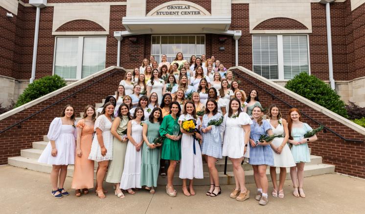 Participants in ETBU's 77th annual Senior Girl Call-Out stand on the back steps of Ornelas Student Center for a group photo