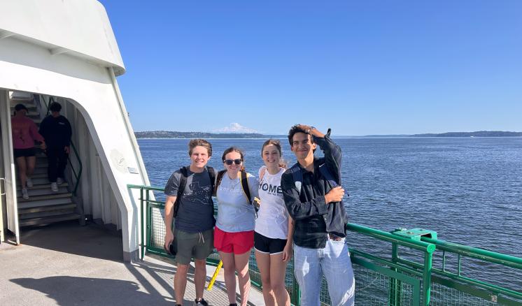 A group of people standing on a boat smiling together outside