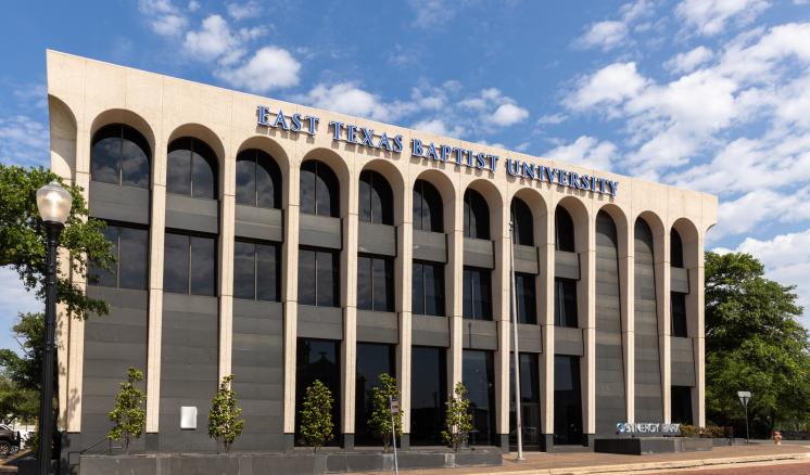 The exterior of a building with writing that says, "East Texas Baptist University"