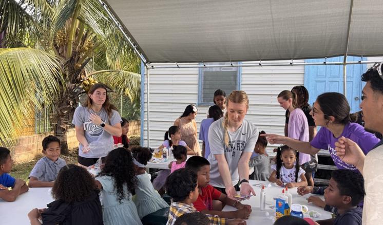 people inside sat at a table smiling and talking