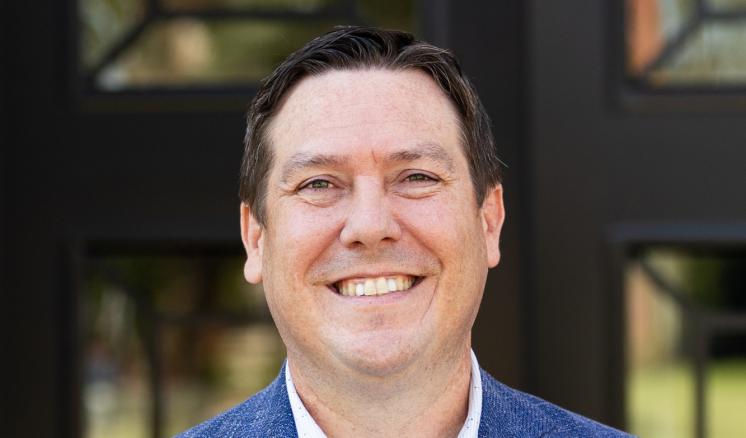 A man stood outside in formal attire