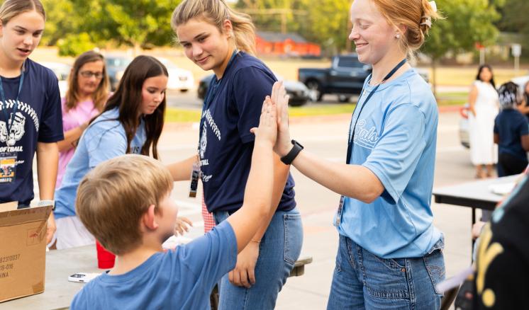 Students high five
