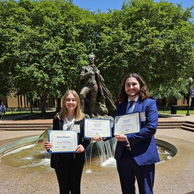 Two students hold awards received at the East Texas Regional Phi Alpha Theta Conference 2024