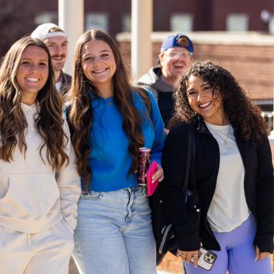 A group of women outside smiling and walking together