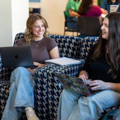 Two students working on laptops