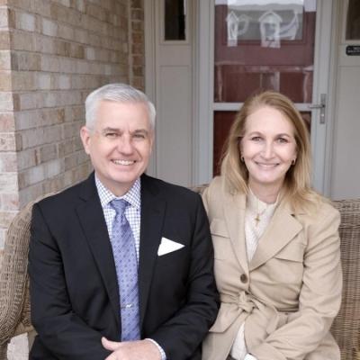Man and woman sitting in front of a door