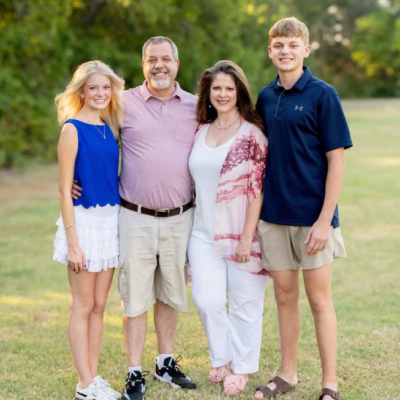 A group of people standing outside for a family photo