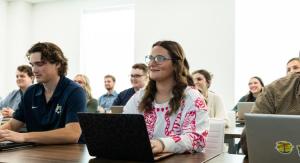 Student on her laptop in a classroom