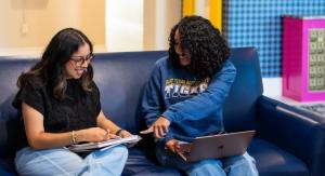 Two students working on laptops