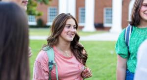 A students with a backpack on smiling