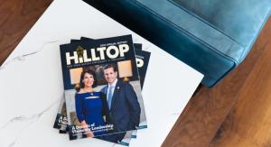 An aerial photo of a table with a magazine upon it that says, "HillTop"