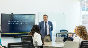 Doctor Lectures in front of board